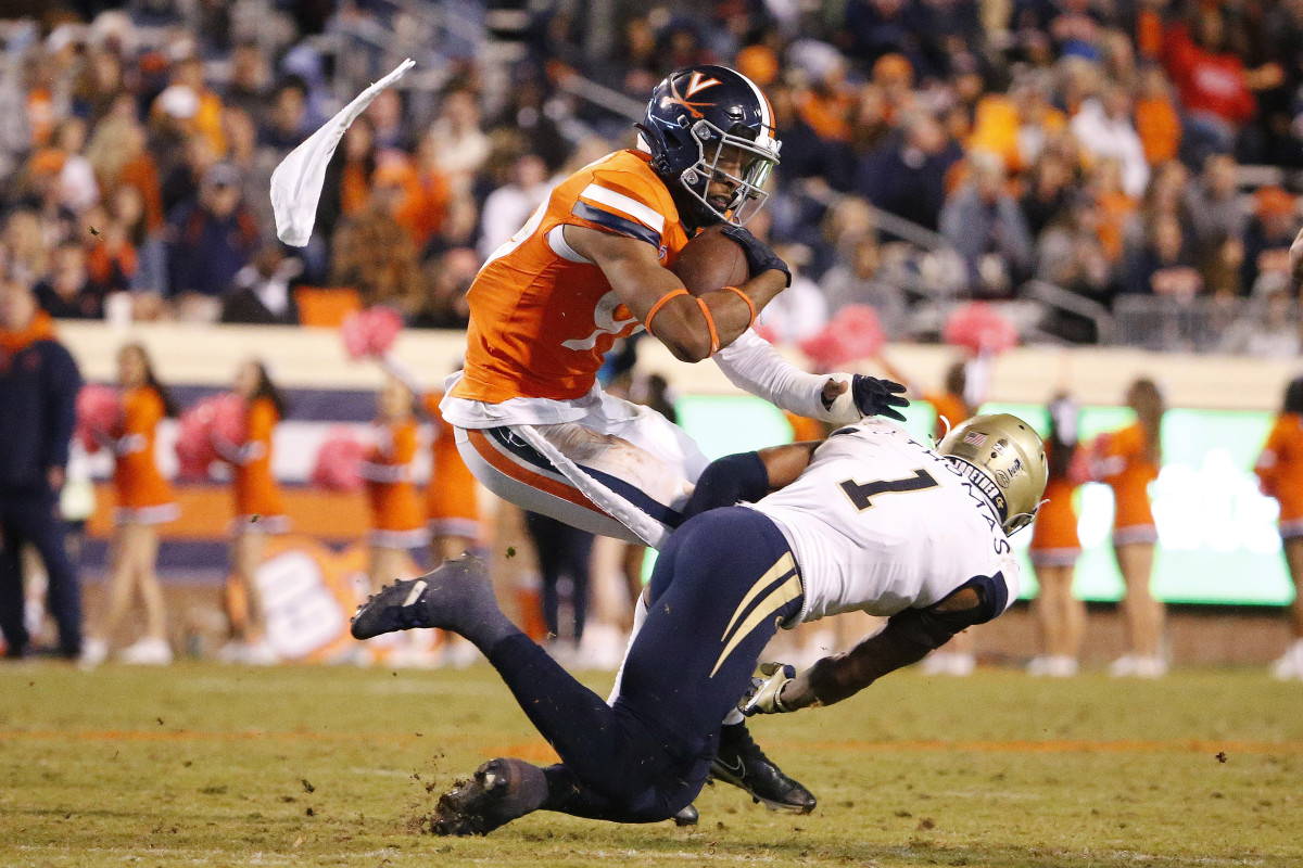 Virginia Cavaliers wide receiver Keytaon Thompson (99) carries the ball as Georgia Tech Yellow Jackets defensive back Juanyeh Thomas (1) defends during the fourth quarter at Scott Stadium.